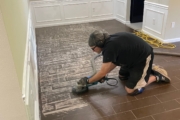 Tiled flooring being ground.