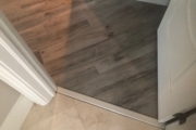 Transition to wood look tile flooring.