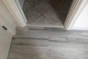 Transition to wood look tile flooring.