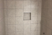 Shower area with new tile installed.