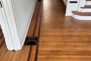 White Oak flooring with Walnut strip trim, after refinishing.