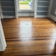 White Oak flooring with Walnut strip trim, after refinishing.