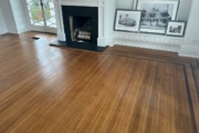 White Oak flooring with Walnut strip trim, before refinishing.