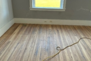 Sanding old Heart Pine flooring.