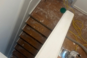 Sanding wood flooring and stair treads.