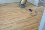 Sanding wood flooring and stair treads.