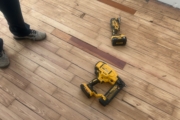 Repair while wooden floors being sanded.