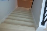 Luxury Vinyl Plank flooring installed on stairs.