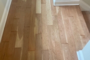 Sanding solid American Cherry wood floors.