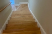 Sanding solid American Cherry wood stairs.