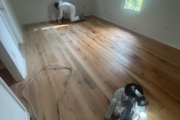 Sanding Oak flooring.