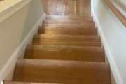 Sanding solid American Cherry wood floors and stairs.