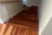 Sanding solid American Cherry wood floors and stairs.