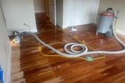 Sanding solid American Cherry wood floors.