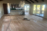 Sanding solid American Cherry wood floors.