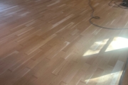 Sanding solid American Cherry wood floors.