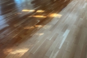 Sanding solid American Cherry wood floors.