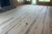 Sanding Heart Pine floors.