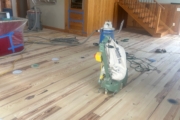 Sanding Heart Pine floors.