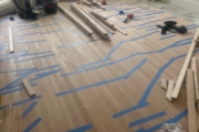 Installing engineered Red Oak flooring.