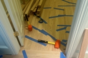 Installing engineered Red Oak flooring.