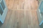 Installing engineered Red Oak flooring.