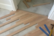 Installing engineered Red Oak flooring.