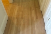 Sanding engineered Red Oak floors.