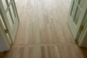 Sanding engineered Red Oak floors.