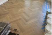 White Oak flooring being installed in herringbone pattern.