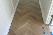 White Oak flooring being installed in herringbone pattern.