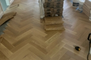 White Oak flooring being installed in herringbone pattern.